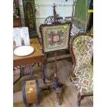 A Victorian rosewood pole screen, the scroll frame with white rose and ribbon embroidery and gilt