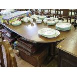 An oak twin pedestal dining table, with two extra leaves, on ring turned columns and quadruped