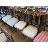A pair of Edwardian inlaid rosewood patera carved lyre shape salon chairs, and another pair of