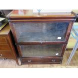 A Globe Wernicke stacking bookcase, with two large glazed fall fronts over a moulded base drawer,