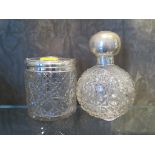 A round cut glass scent bottle with stopper and silver top