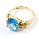A 9 carat gold ring set with an oval blue topaz and diamonds, with certificate