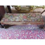 A George III style mahogany long stool, the tapestry top on carved cabriole legs and scroll feet,