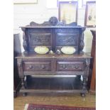 A Victorian carved oak buffet, the raised back with lion mask, dragon carved panels and figural