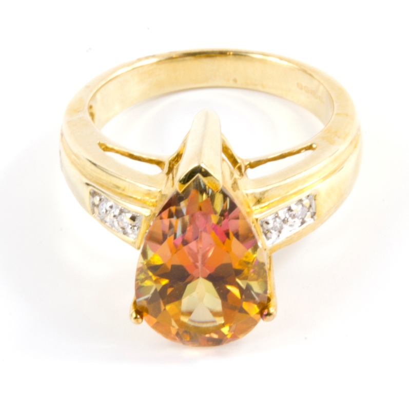 A topaz and diamond ring set in 9 carat yellow gold