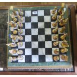 A gilded cast metal chess set, the pieces in the form of Egyptian figures, and a marble board with