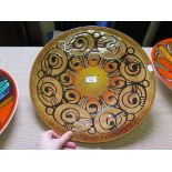 A Poole pottery Aegean range charger, with a large abstract design, artist unknown, 41cm diameter