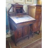 An Edwardian inlaid rosewood Davenport, the raised mirrored back with tambour front and drawers,