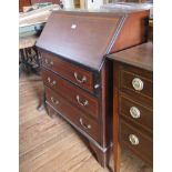 An Edwardian mahogany and satinwood crossbanded bureau, with sloping fall front above three long