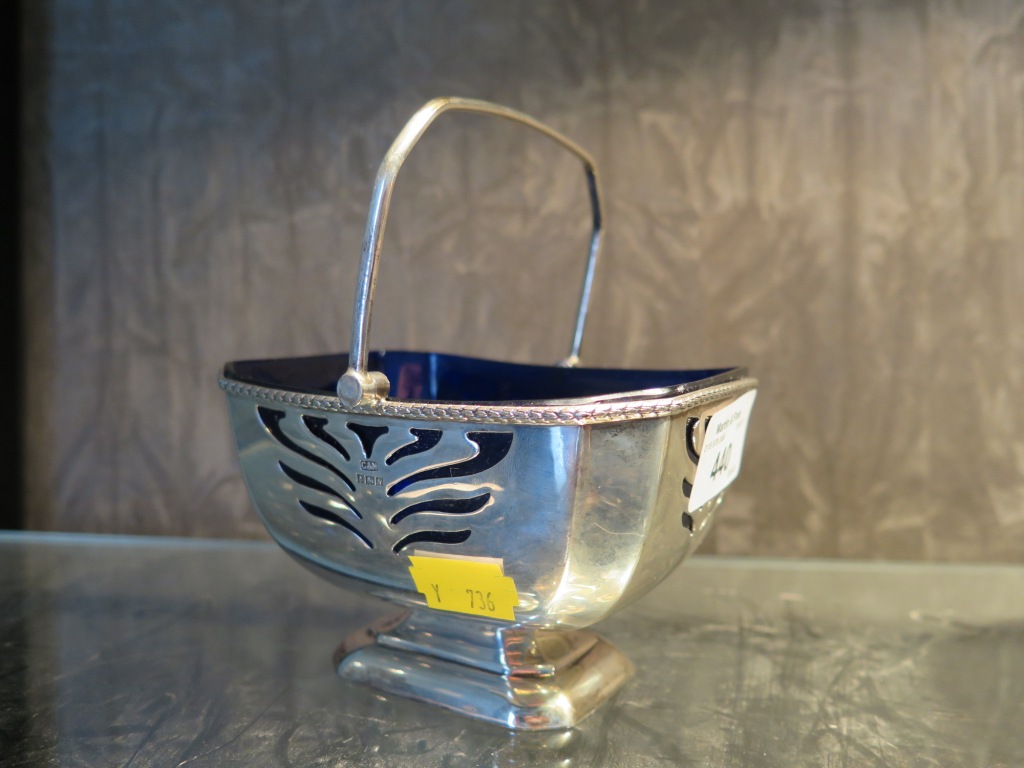 A swing handle silver sugar basket with blue liner, the basket with pierced decoration, Birmingham