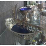 A silver basket having pierced decoration and a miniature silver Chinese junk