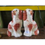 A pair of mid 19th century Staffordshire russet red and white spaniel dogs, circa 1860s one as found