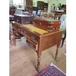 An Edwardian lady's writing table, the leather inset top over four drawers on ring turned legs and