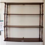 A Regency style four tier mahogany wall shelf, with ring turned baluster supports, 70cm square