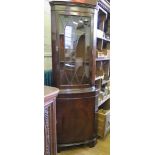 A reproduction mahogany corner cabinet, with glazed and cupboard doors, 65cm wide, 180cm high