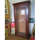 A Victorian mahogany bookcase, the moulded cornice over a single glazed door on a plinth base, 104cm