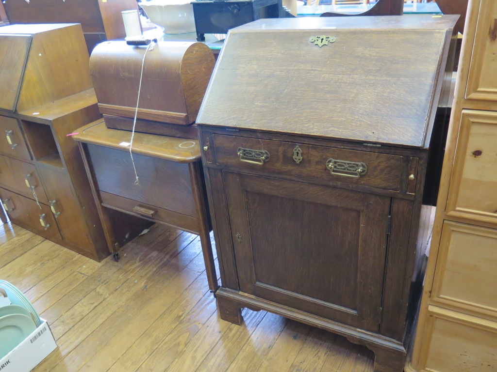 An oak sewing box with hinged lid and frieze drawer, a Singer sewing machine, and an oak bureau (3)