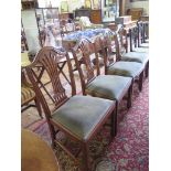 A set of four George III style mahogany dining chairs, the shaped top rail over pierced vase shape