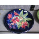 A Moorcroft Simeon pattern charger with blue ground dated 1999, with impressed and painted marks and