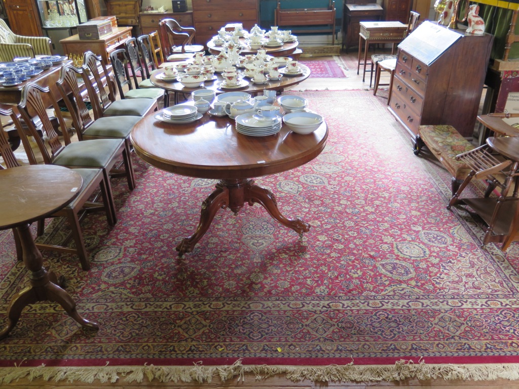 A Heriz style carpet, with red field, radiating medallion and lanterns filled with floral scrolls