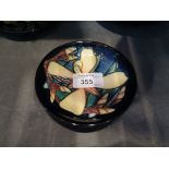 A Moorcroft Orchid pattern circular pin tray, blue ground, impressed mark dated 2004 and