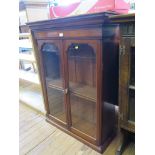A Victorian walnut bookcase, the moulded cornice over two glazed doors, 84cm wide 107cm high