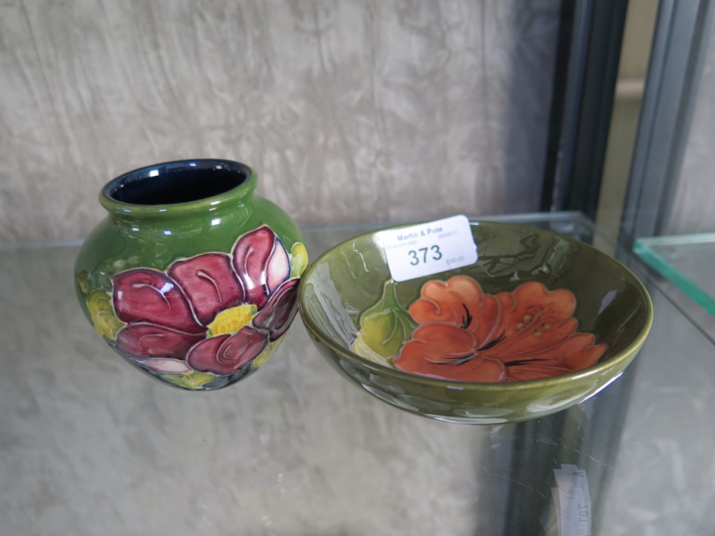A Moorcroft pink hibiscus dish, impressed mark 11.5cm diameter, and a pansy vase 17cm high