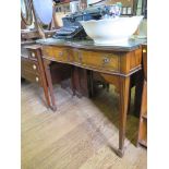 A reproduction mahogany serving table with two bowed frieze drawers on fluted tapering legs and