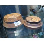 A pair of Black Forest carved wood table snuff boxes, the lids depicting profile faces 14cm diameter