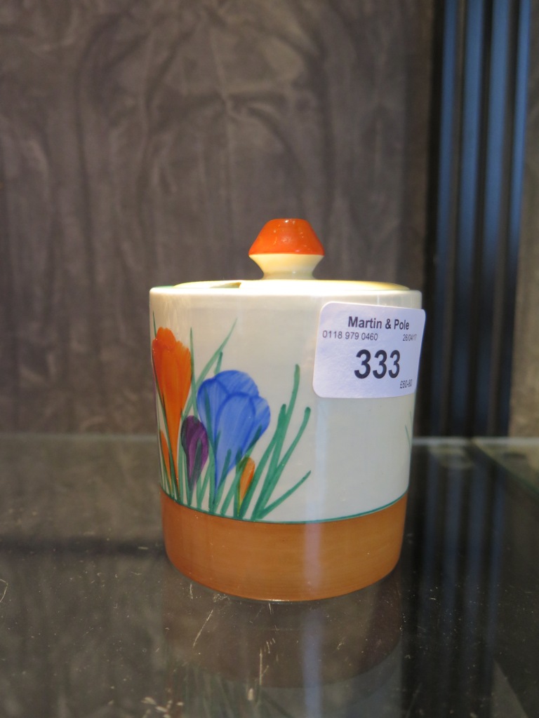 A Clarice Cliff for Newport pottery crocus pattern jam pot and cover, 9cm high