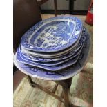 Two 19th century blue and white meat plates, with gravy moulding, both willow pattern and five other