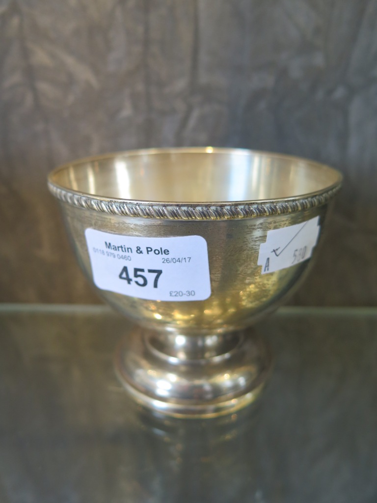 A silver bowl on stepped single foot