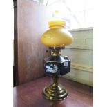 A Victorian style brass oil lamp with black ceramic resevoir, 55cm high