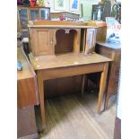 An oak lady's desk, the top with panelled doored pigeonholes on square tapering legs with club feet,