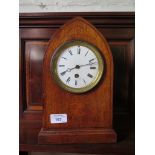 An Edwardian oak and chevron banded mantel clock, the lancet arched case with inlaid patera