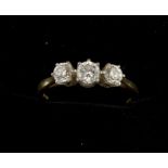 A fine quality three stone diamond ring set in 18 carat gold and platinum. Total diamond weight