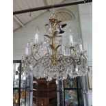 A six branch gilt metal chandelier with faceted glass pendants and swags, 55cm wide