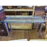 An aluminium and glass console table, in the style of Alessandro Albrizzi with column form legs,