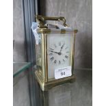 An Edwardian brass carriage clock of conventional form with enamel dial, the twin train movement