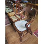 A 1920s mahogany office chair, with rail back, upholstered seat and cabriole legs joined by