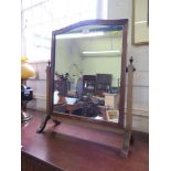 A mahogany toilet mirror, with shaped top and outsplayed legs 54cms wide, 63cm high