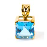 A 9 carat gold pendant set with a blue topaz, with certificate