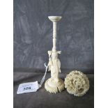 An early 20th century ivory puzzle ball on a figural stand