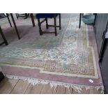 A French style wool carpet, the salmon pink field with floral medallion and border, in an ivory