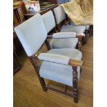 A set of five Commonwealth style oak dining chairs, including a carver, with blue upholstered