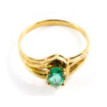 An emerald and diamond ring set in 9 carat yellow gold