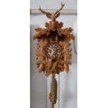 A 20th century Black Forest type carved wood cuckoo clock, 29cm high