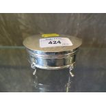 A silver trinket box on four feet