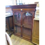 A Victorian walnut bookcase, the moulded cornice over two glazed doors, 84cm wide 107cm high