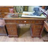 A reproduction mahogany pedestal desk, with leather top and filing drawer 120cm wide